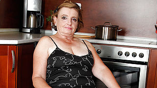 Naughty mature lady playing in the kitchen